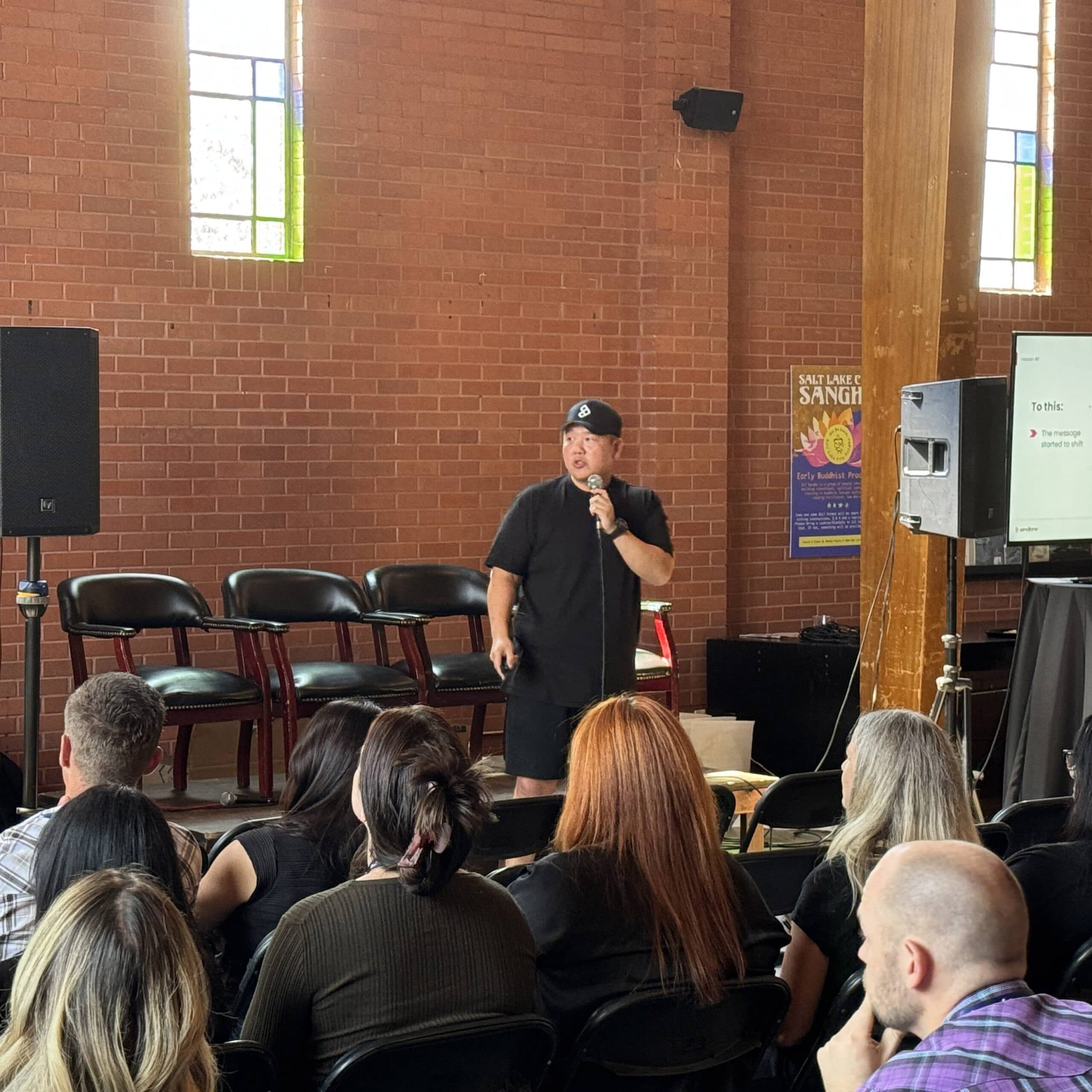 A speaker with a mic at a Commerce Catalyst event